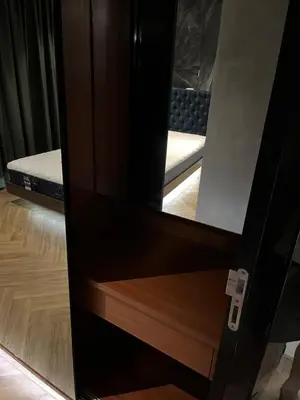 a door with a mirror in a bedroom at Spaceous Appartment on Sukhumvit in Bangkok