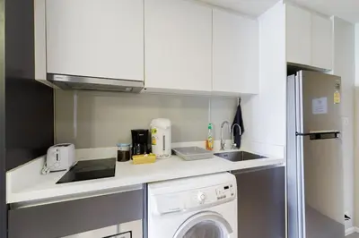 a small kitchen with a washer and dryer in it at Relaxing place in Downtown, BKK in Bangkok