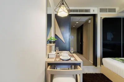 a room with a table and a bed and a room with a bed at Relaxing place in Downtown, BKK in Bangkok