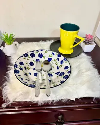a table with a plate with a spoon and fork at Ally home 12 23 in Thung Si Kan