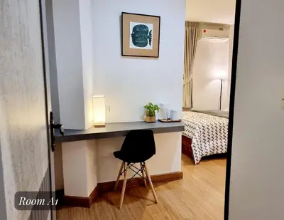 a room with a desk with a chair and a bed at Friend Nest Bangkok in Bangkok