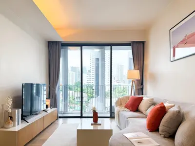 a living room with a couch and a large window at Expansive Luxury 2BR - Ultra Fast Wifi - Phrom Phong in Bangkok