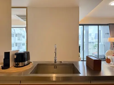 a kitchen with a sink and a microwave at Expansive Luxury 2BR - Ultra Fast Wifi - Phrom Phong in Bangkok