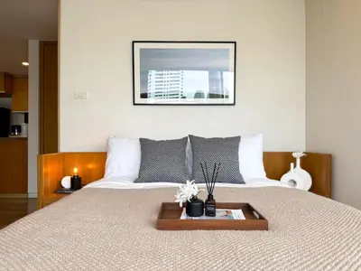 a bedroom with a large bed with a tray on it at Expansive Luxury 2BR - Ultra Fast Wifi - Phrom Phong in Bangkok