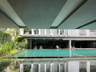 a swimming pool in the middle of a building at Expansive Luxury 2BR - Ultra Fast Wifi - Phrom Phong in Bangkok