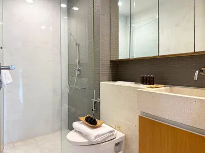 a bathroom with a shower and a toilet and a sink at Expansive Luxury 2BR - Ultra Fast Wifi - Phrom Phong in Bangkok