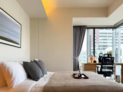 a bedroom with a bed and a large window at Expansive Luxury 2BR - Ultra Fast Wifi - Phrom Phong in Bangkok