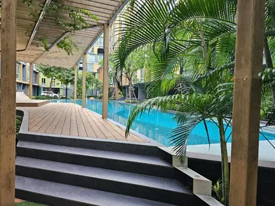 a swimming pool with stairs next to a building at Metroluxe rama4 , city center in Bangkok