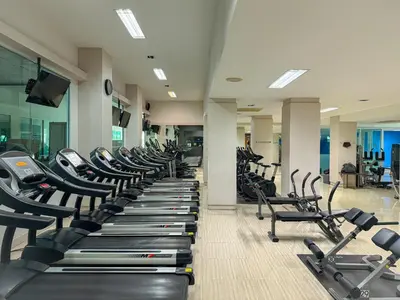 a gym with a row of treadmills and machines at Avana Residence in Bangna