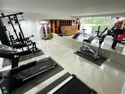 a gym with several treadmills and machines in a room at Prestige in Bangna