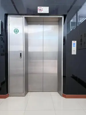 a large metal elevator in a building at Prestige in Bangna