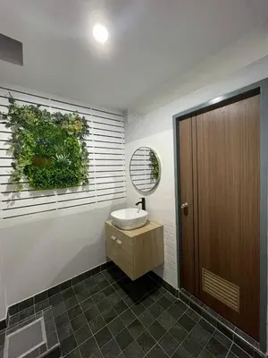 a bathroom with a sink and a mirror on the wall at Ananta House in Bang Su