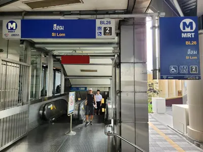 a group of people walking into a subway station at Be Cozy Silom Modern 2BR 1-min to BTS & MRT in Bangkok