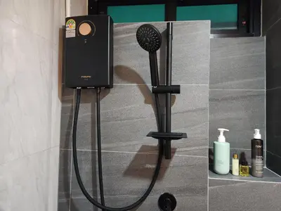 a shower with a blow dryer in a bathroom at Be Cozy Silom Modern 2BR 1-min to BTS & MRT in Bangkok