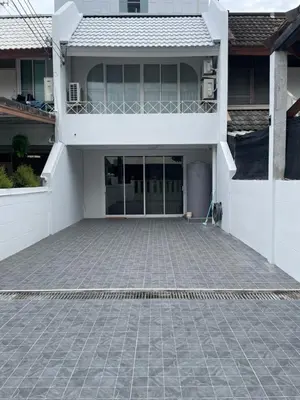 an empty parking lot in front of a house at Kin Bangkok in Bangkok
