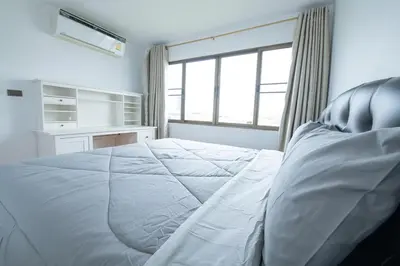 a bedroom with a large white bed and a window at 2Bed Room Condo Near iConsiam & BTS Krungthonburi in Bangkok