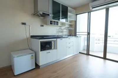 a kitchen with white cabinets and a stove top oven at 2Bed Room Condo Near iConsiam & BTS Krungthonburi in Bangkok