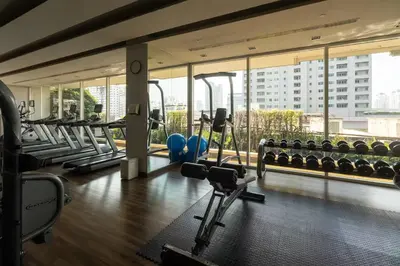 a gym with treadmills and machines in a building at Luxury Condo with Swimming Pool, Fast Wifi, 711, Big Room, Jacuzzi in Bangkok