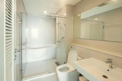a bathroom with a shower and a toilet and a sink at Luxury Condo with Swimming Pool, Fast Wifi, 711, Big Room, Jacuzzi in Bangkok