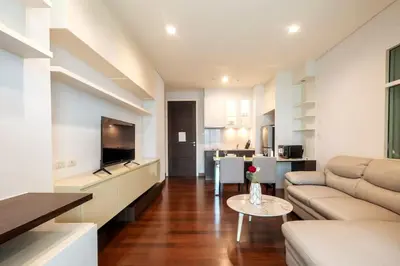 a living room with a couch and a table at Luxury Condo with Swimming Pool, Fast Wifi, 711, Big Room, Jacuzzi in Bangkok