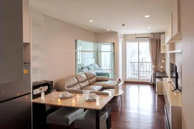 a living room with a couch and a table at Luxury Condo with Swimming Pool, Fast Wifi, 711, Big Room, Jacuzzi in Bangkok