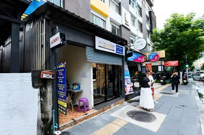 a woman standing outside of a store on a city street at XX Oh My Nap Sukhumvit 3 - สุขุมวิท 3 in Makkasan
