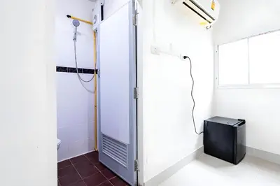 a bathroom with a shower stall and a television at XX Oh My Nap Sukhumvit 3 - สุขุมวิท 3 in Makkasan