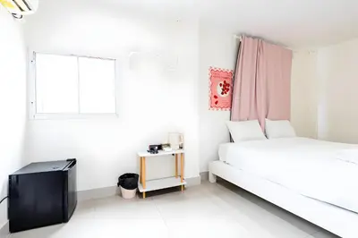 a white bedroom with a bed and a window at XX Oh My Nap Sukhumvit 3 - สุขุมวิท 3 in Makkasan
