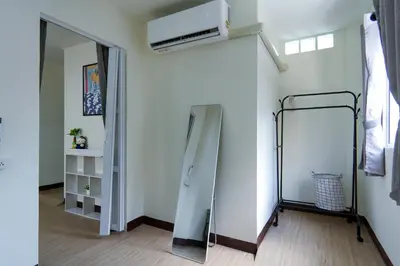 a room with a mirror and a air conditioner at Baan ABC at 112 Phahonyothin 55 in Bang Khen