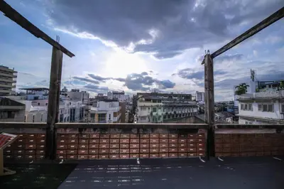 a view of a city skyline from a balcony at The Open House Cafe and Hostel in Bangkok