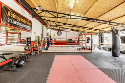 a gym with a boxing ring with a punching bag at Room 1 Homestay Near BTS Bangwa & Train Muaythai in Bangkok