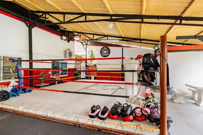 a boxing ring with a bunch of boxing gloves at Room 1 Homestay Near BTS Bangwa & Train Muaythai in Bangkok