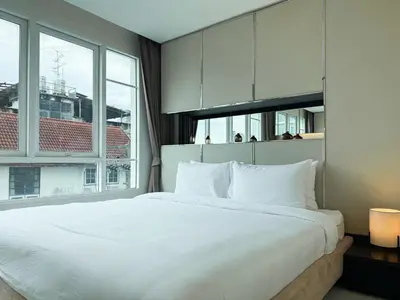 a bedroom with a large white bed with a large window at Modern Stay Near ICONSIAM l Steps to BTS Krung Thon Buri l Ultra Fast WiFi in Bangkok