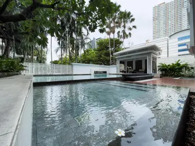 a swimming pool in front of a building at Modern Stay Near ICONSIAM l Steps to BTS Krung Thon Buri l Ultra Fast WiFi in Bangkok