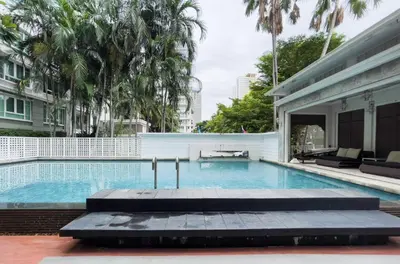 a swimming pool in the middle of a building at Modern Stay Near ICONSIAM l Steps to BTS Krung Thon Buri l Ultra Fast WiFi in Bangkok