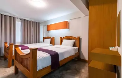 a bedroom with two beds and a window at XX GO INN Khaosan โก อินน์ ตรอกข้าวสาร in Bang Bua Thong Railway Station