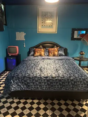 a bed in a bedroom with a blue wall at The oasis on 8 City blue 2