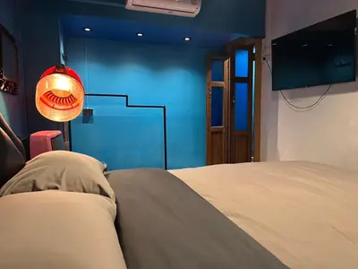 a bedroom with a bed and a blue wall at The oasis on 8 City blue 2