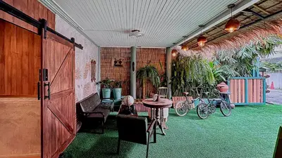 a room with a table and chairs and some plants at The oasis on 8 City blue 2