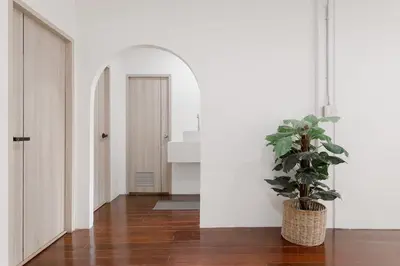 a hallway with a potted plant and a door at 4BR 8PAX Near BTS Mochit MRT Chatuchak Union Mall in Sathani Bang Su