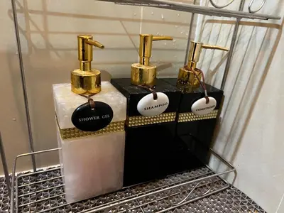 a group of three perfume bottles on a shelf at Cozy Private Home I Steps to BTS & MRT Sukhumvit Minimum 14 nights in Bangkok