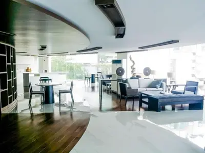 a living room with a couch and tables and chairs at Cozy Private Home I Steps to BTS & MRT Sukhumvit Minimum 14 nights in Bangkok