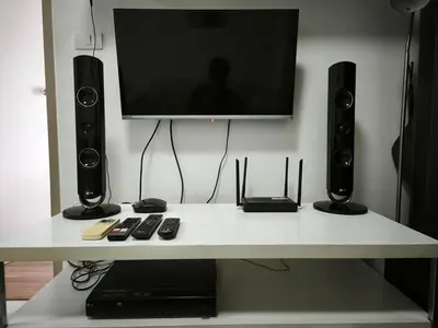 a white table with two speakers and a tv on top at Condo 1B1BR Sukhumvit 103 BTS Udomsuk in Phra Khanong