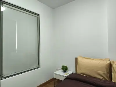 a bedroom with a large window next to a bed at Condo 1B1BR Sukhumvit 103 BTS Udomsuk in Phra Khanong