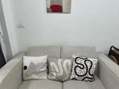 a couch with pillows on it in a living room at Condo 1B1BR Sukhumvit 103 BTS Udomsuk in Phra Khanong