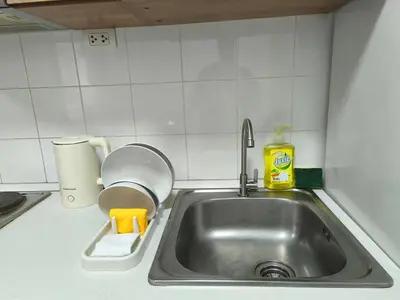 a kitchen sink with a sponge and a bottle of detergent at Condo 1B1BR Sukhumvit 103 BTS Udomsuk in Phra Khanong