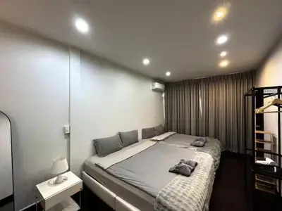 a bedroom with a large bed in a room at 4BR 12PAX 7min walk to Samitivej Sukhumvit Hospital in Khlong Toei