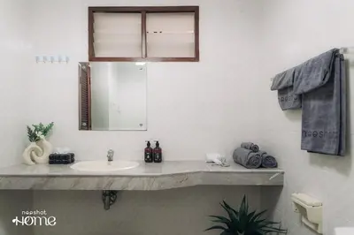 a bathroom with a sink and a mirror at 4BR 10PAX Ensuite Near EmQuartier Emporium Emsphere in Khlong Toei