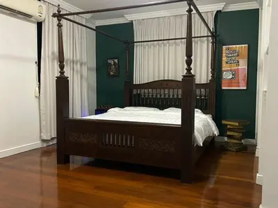 a canopy bed in a bedroom with green walls at The oasis on 8 3 bedrooms private zone in Bang Kapi