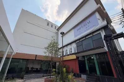 a building with a sign on the side of it at The Grand Imperial in Ban Song Hong